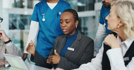 Hospital staff meeting around a table